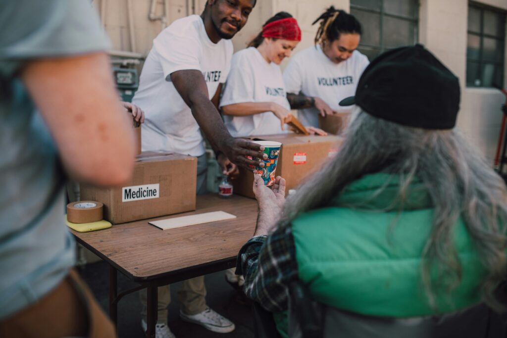 Volunteers handing out donations and support to those in need at a community event.